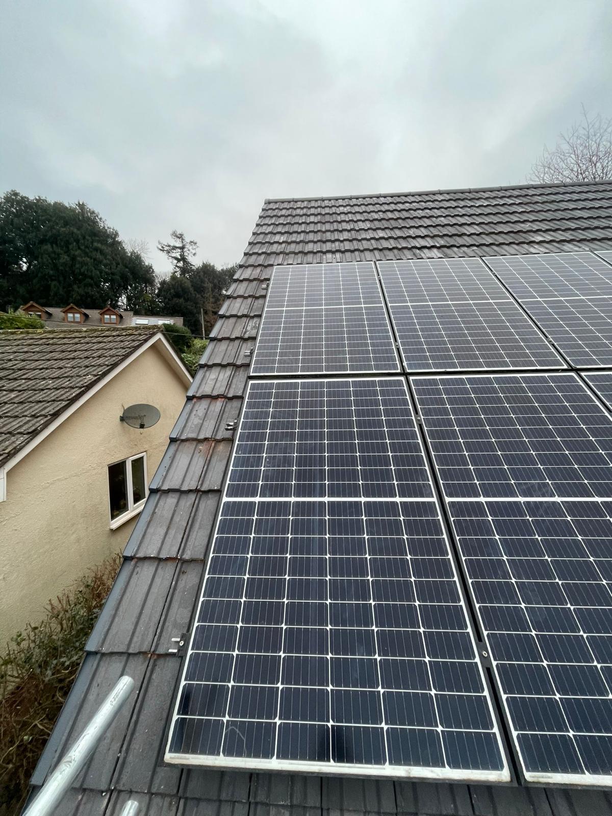 Solar PV panels installed alongside existing tiled roof in Surrey