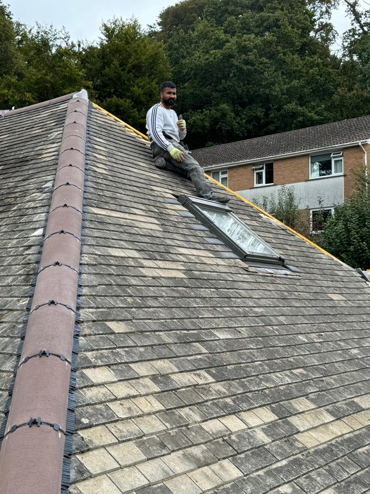 Alpha Roofcare craftsman on a re-roof with newly fitted Velux skylight