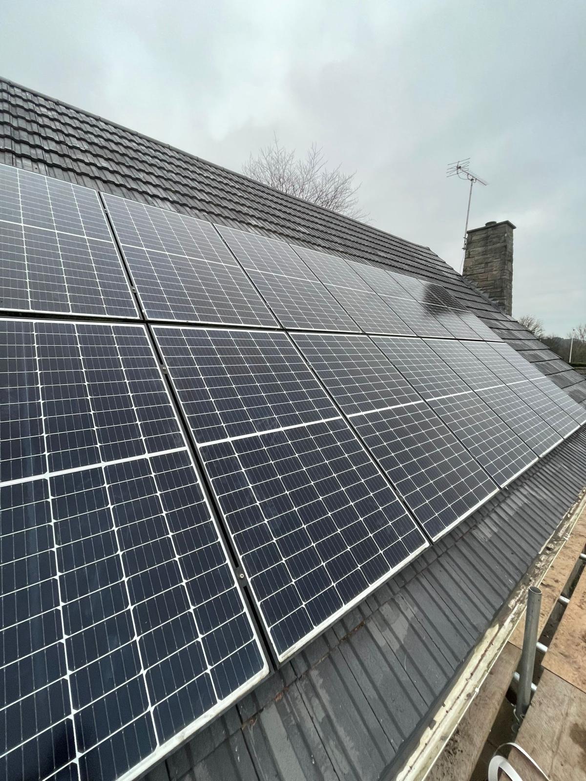 In-roof solar panel array integrated with black concrete tiles