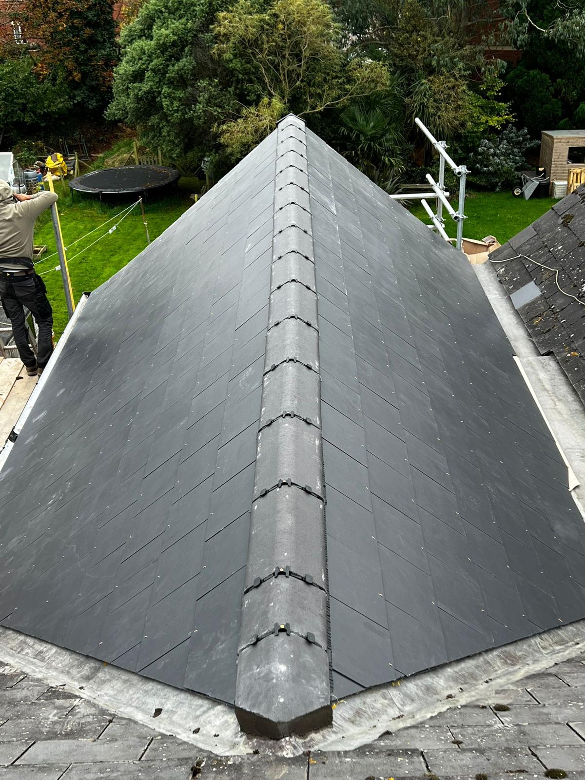Newly completed natural slate hipped roof with dry-ridge system