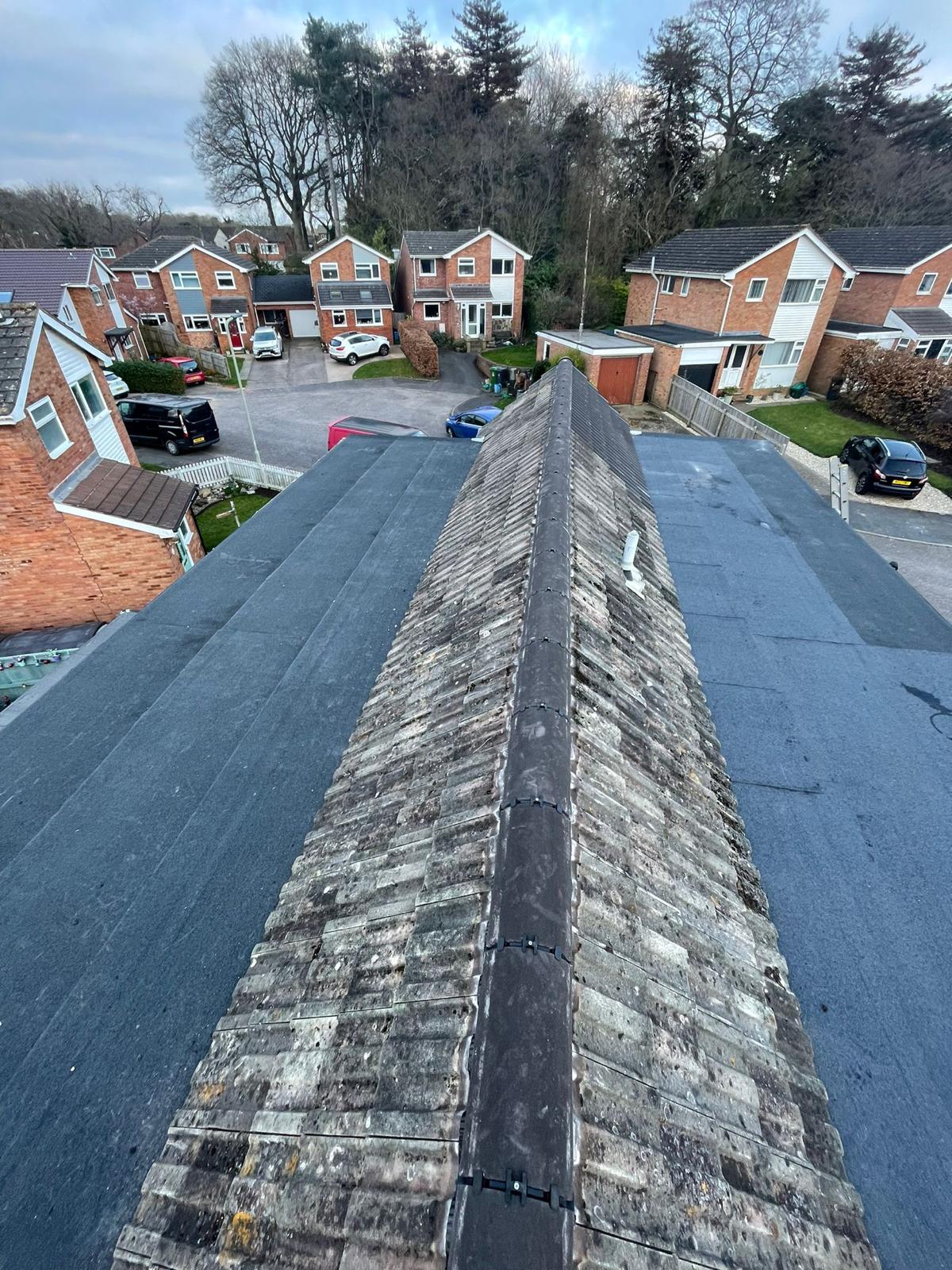 New flat roof and re-bedded ridge tiles overlooking a Surrey estate